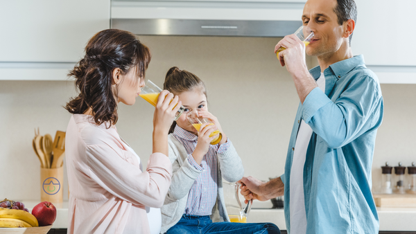 Family preparing electrolytes in the morning sunlight to start their day.